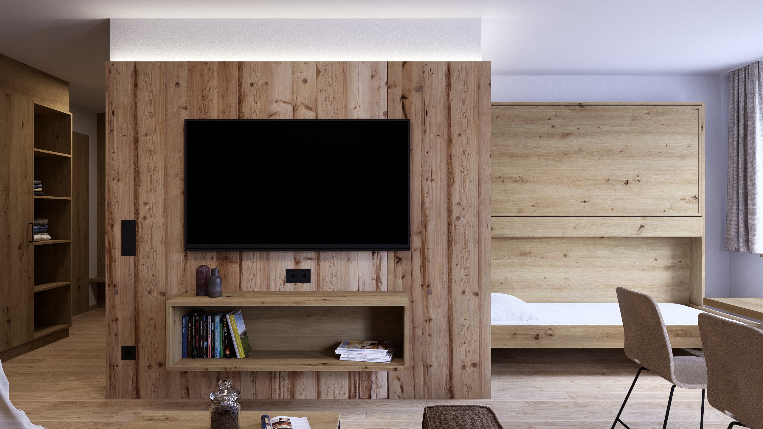 Wohnbereich mit TV und Schlafnische in der Ferienwohnung